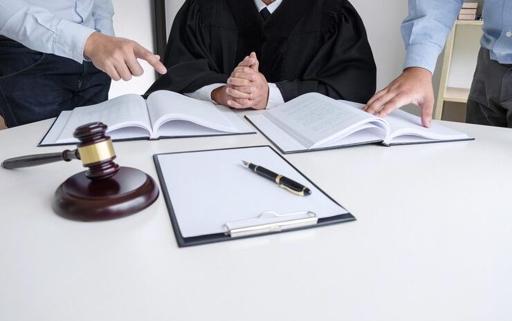 midsection judge sitting amidst business colleagues desk office 28283 12916 e1772616264488